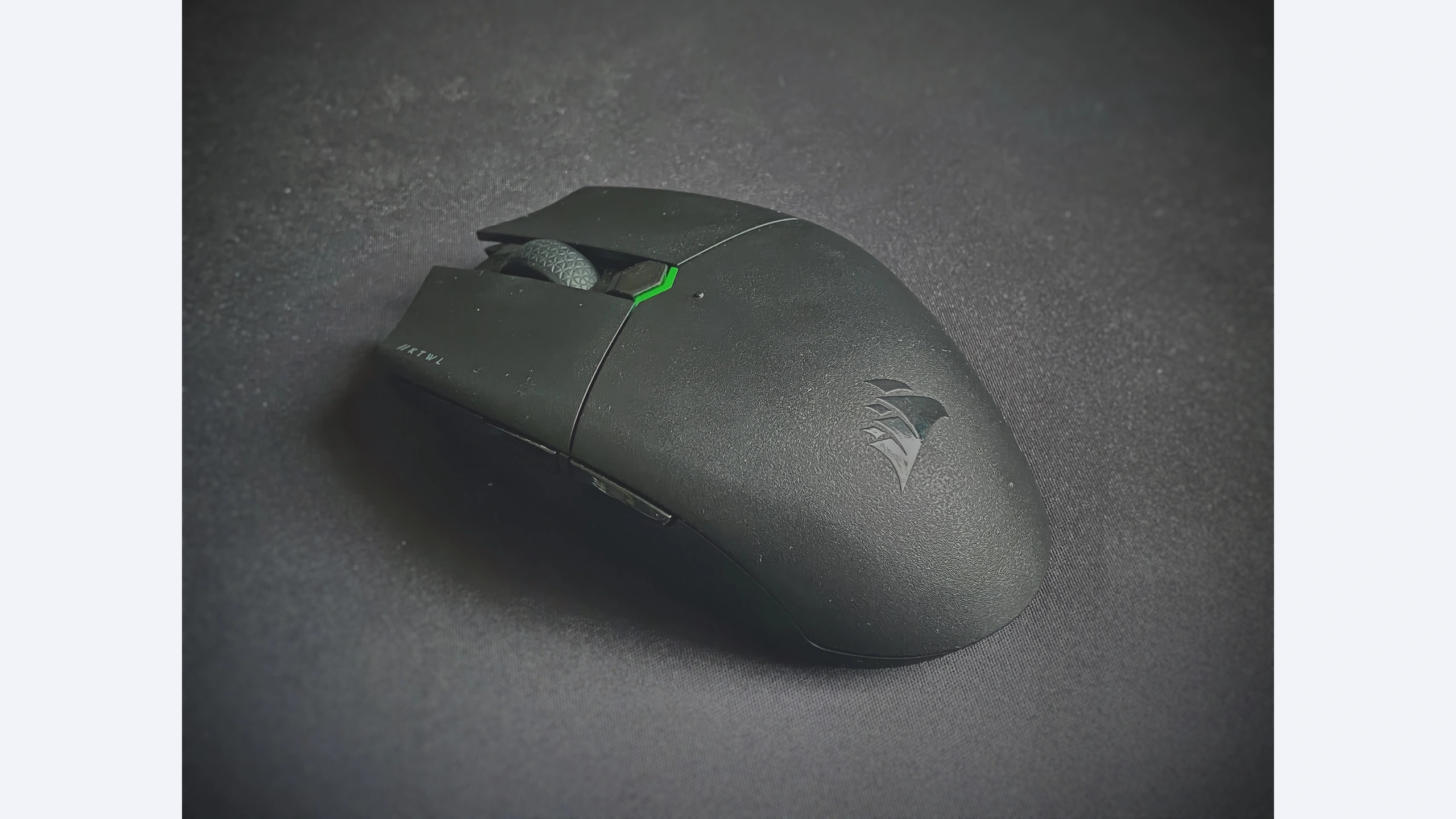 Black Corsair KATAR PRO WIRELESS mouse photographed from above on a dark desk