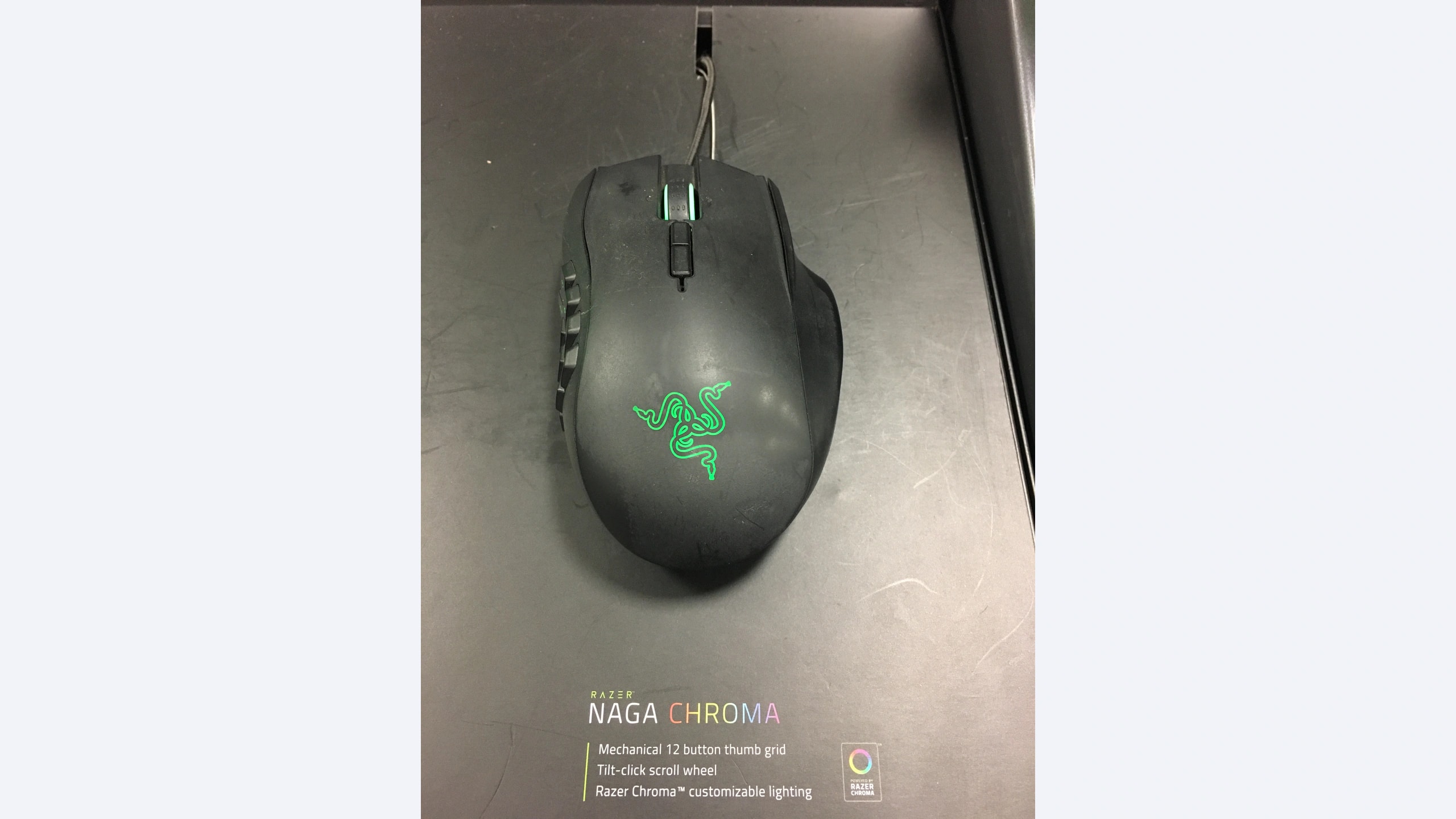Razer Naga Chroma wired mouse on its exhibition display with twelve-button thumb grid